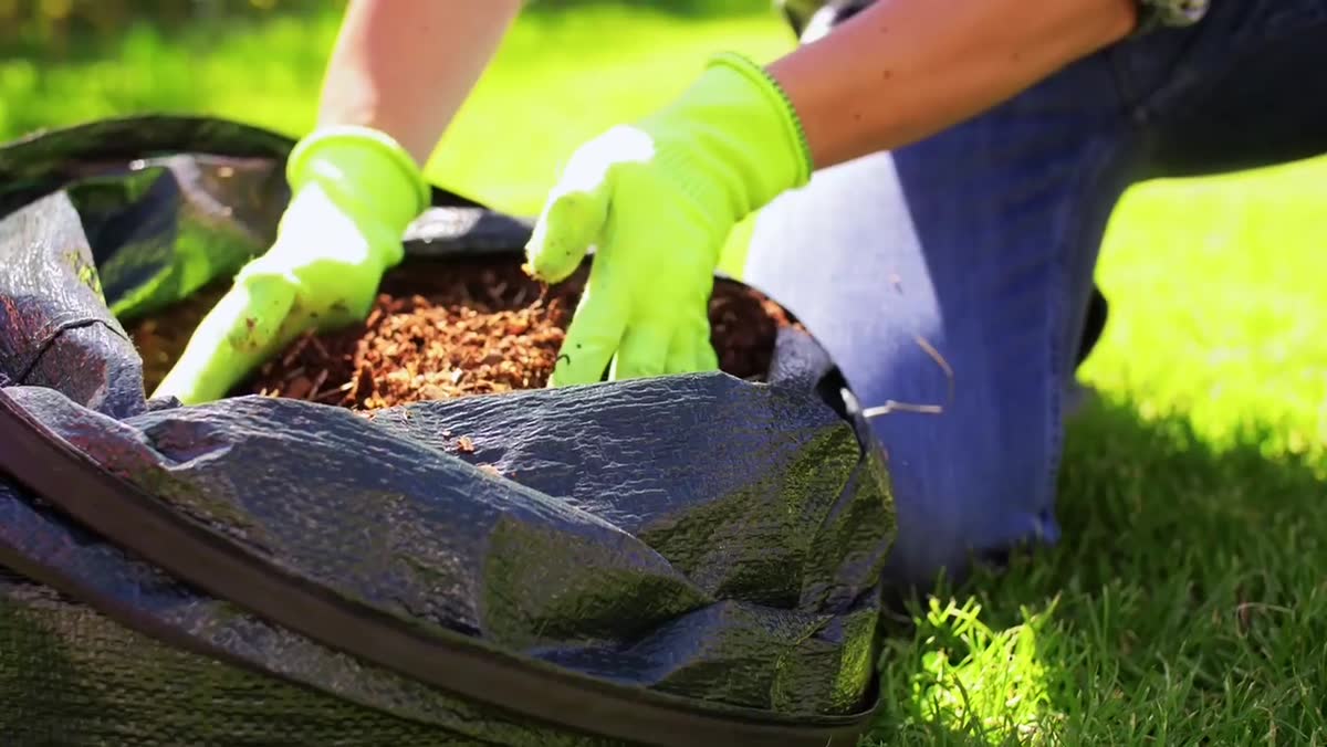 Fresh mulch being installed in a garden bed